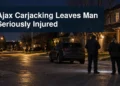 Nighttime Ajax residential investigation scene with the headline Ajax Carjacking Leaves Man Seriously Injured