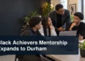 Black mentors and students in a workshop with the headline Black Achievers Mentorship Expands to Durham