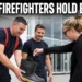 Oshawa firefighters collecting donations in a boot outside a shopping centre