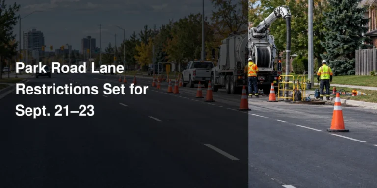 Lane restriction signs and utility crews on Park Road South in Oshawa