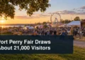Busy agricultural fair at sunset with the headline Port Perry Fair Draws About 21,000 Visitors