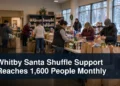 Whitby volunteers organizing food and holiday support with the headline Whitby Santa Shuffle Support Reaches 1,600 People Monthly