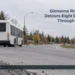 AI editorial illustration: Unbranded transit bus and orange construction cone on a suburban road. Headline: Glenanna Road Closure Detours Eight DRT Routes Through October 26. AllAboutDurham.com.