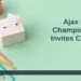 AI editorial illustration: Small practice ballot box, children’s books and coloured pencils on a mint tabletop. Headline: Ajax Library Champion Vote Invites Children. AllAboutDurham.com.
