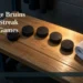 AI editorial illustration: Five hockey pucks on a wood bench representing the Bruins’ five-game streak. Headline: Uxbridge Bruins Extend Streak to Five Games. AllAboutDurham.com.