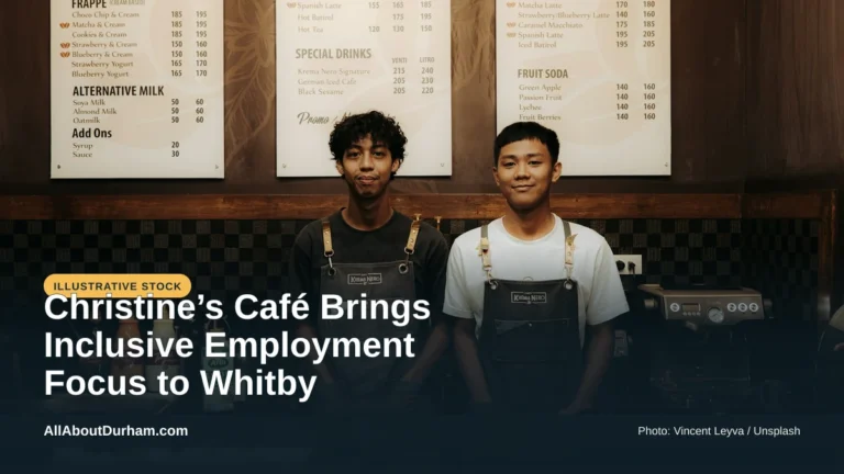 Illustrative stock photo: Two baristas smiling behind a counter. Photo by Vincent Leyva on Unsplash. Headline: Christine’s Café Brings Inclusive Employment Focus to Whitby. AllAboutDurham.com.