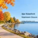 Original conceptual illustration of an autumn lakeside path and a generic public amenity building; not a photograph of Veteran’s Point.