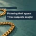 Editorial illustration: a plain gold chain on a teal surface, not the stolen necklace.